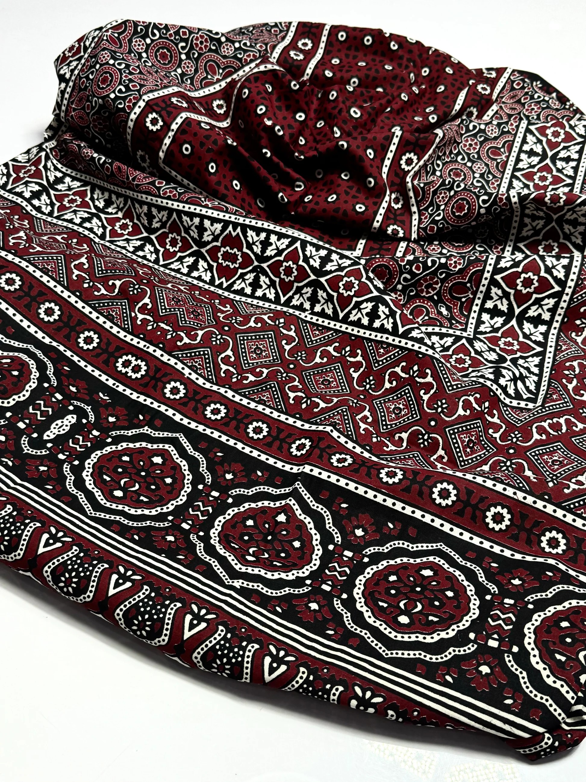 Ajrakh chadar textile photographed from an angled product view